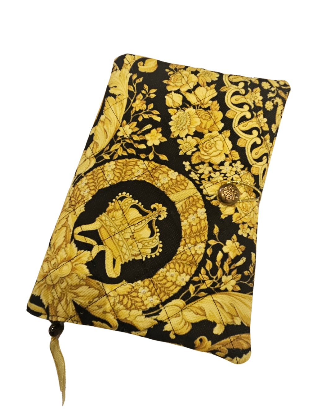 Decorative notebook with gold floral and emblem design on black background