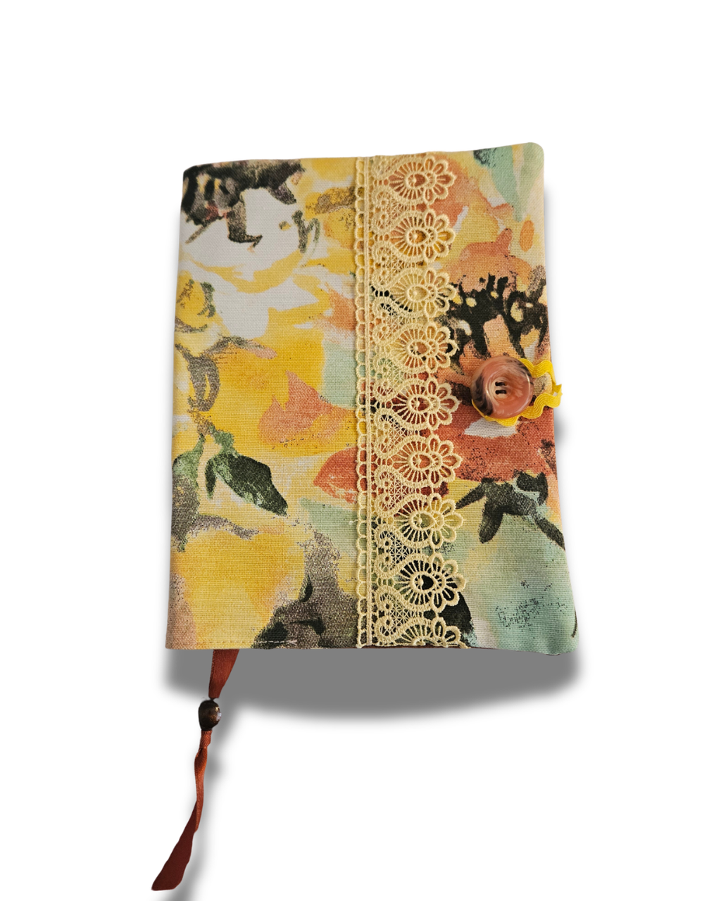 Floral patterned notebook cover with lace detail on a white background