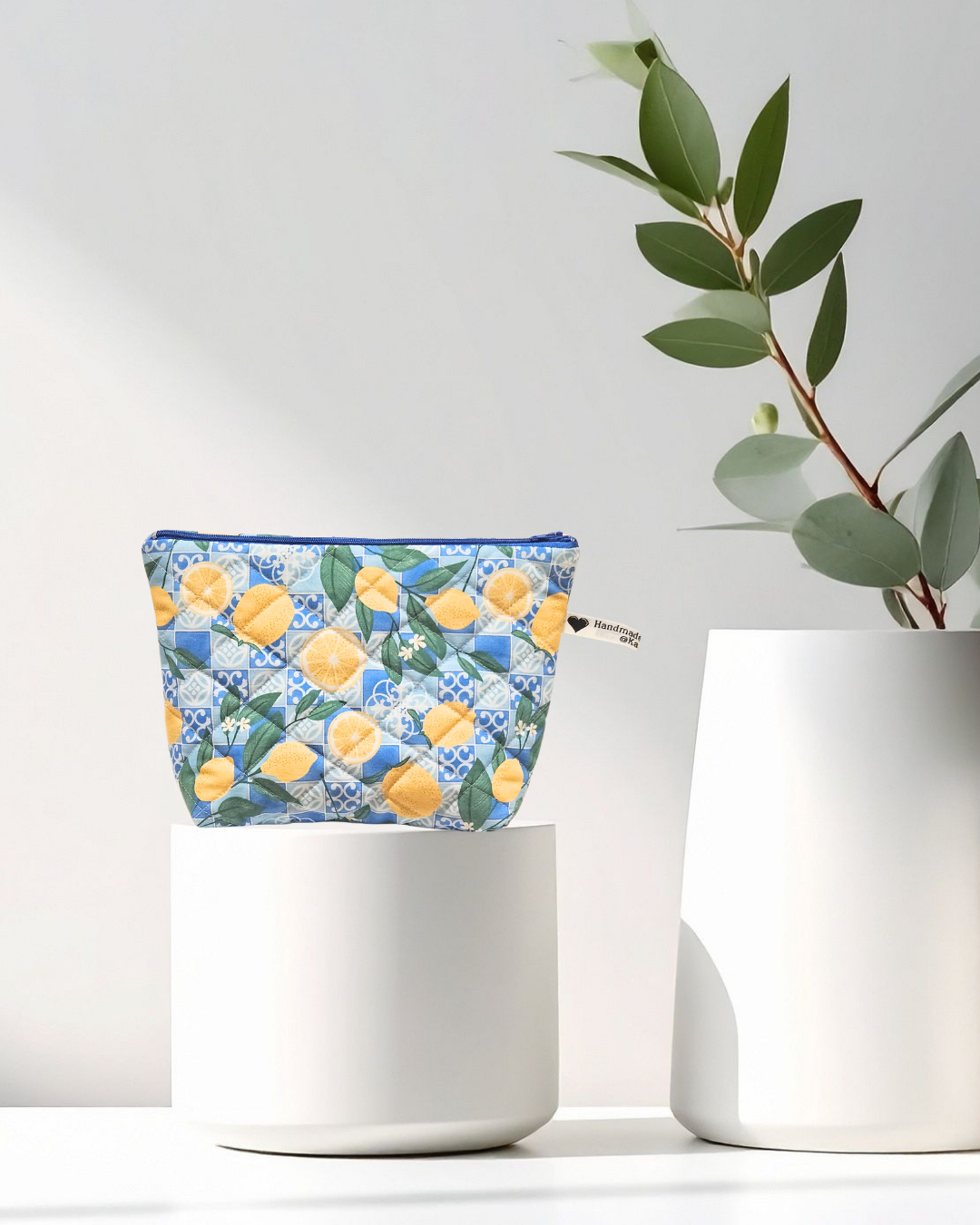 quilted pouch with lemon and blue tile pattern on white background