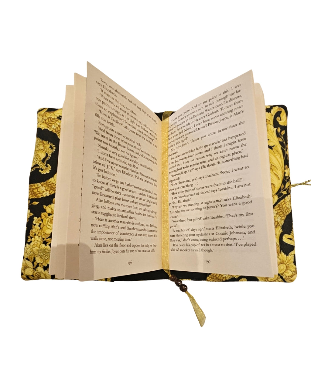Open book on a decorative yellow and black patterned pillow