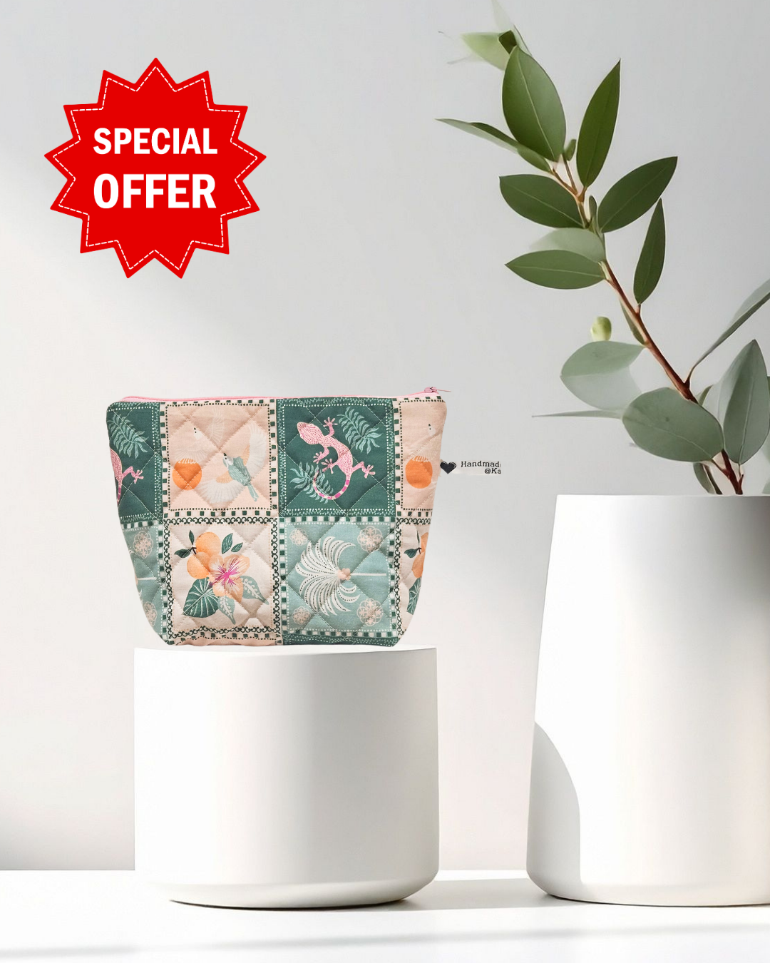 Decorative pot with a patchwork design next to a white vase on a light background