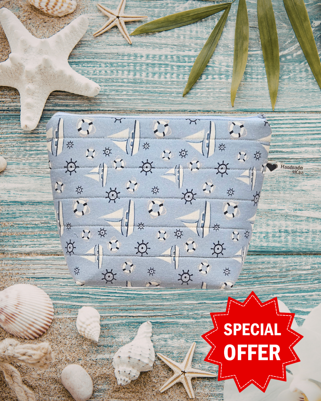 Fabric pouch with nautical pattern on a beach-themed background with shells and starfish.