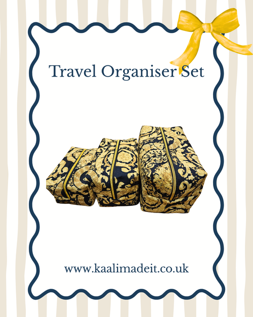 A travel organiser set with three zippered pouches in a black and gold damask pattern, presented on a white card with a blue wavy border, a yellow bow, and the text 'Travel Organiser Set' and 'www.kaalimadeit.