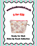 A quilted make-up pouch with a pink and beige floral print, presented on a white background with a decorative black scalloped border. The image includes promotional text reading 'www.