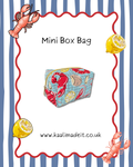 A product listing graphic for a 'Mini Box Bag' featuring a central photo of a zippered pouch with a lobster and lemon print on a blue grid background. The image is framed by a red wavy border on a blue and white striped background, decorated with cartoon lobster and lemon illustrations, and includes the website 'www.kaalimadeit.co.uk