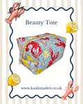 A square canvas beauty tote bag with a lobster and lemon print, displayed on a white background with decorative cartoon lobster and lemon illustrations and the text 'Beauty Tote' and 'www.kaalimadeit.