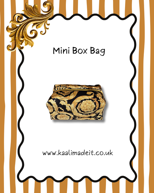 A mini box bag with a black and gold baroque pattern, presented on a white card with a wavy black border, gold scrollwork, and a gold-and-white striped background. Text on the image reads 'Mini Box Bag' and 'www.kaalimadeit.co.uk