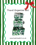 A travel organizer set featuring three matching zippered pouches with a green and white tropical leaf pattern, presented on a white background with a green wavy border, green vertical stripes, a red bow, and the text 'Travel Organiser Set' and 'www.kaalimadeit.