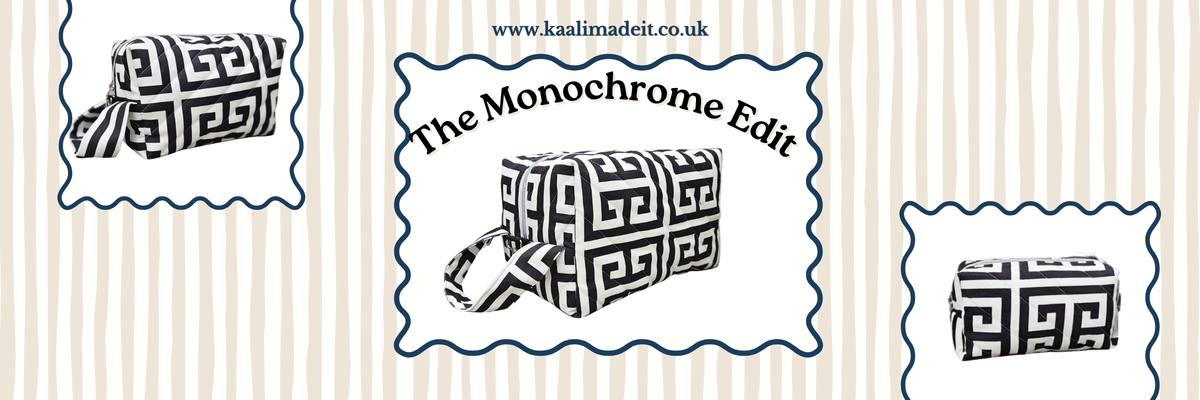 A fabric zippered pouch with a black and white Greek key pattern, shown in three views on a cream and beige striped background with the text 'The Monochrome Edit' and a website URL.