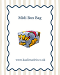 A fabric midi box bag with a colorful African print pattern of yellow, black, white, and red, presented on a white card with a wavy blue border and text reading 'Midi Box Bag' and 'www.kaalimadeit.