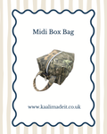 A camouflage midi box bag with a top zipper and carrying handle, centered on a white background with a navy scalloped border, the text 'Midi Box Bag,' and the website 'www.kaalimadeit.