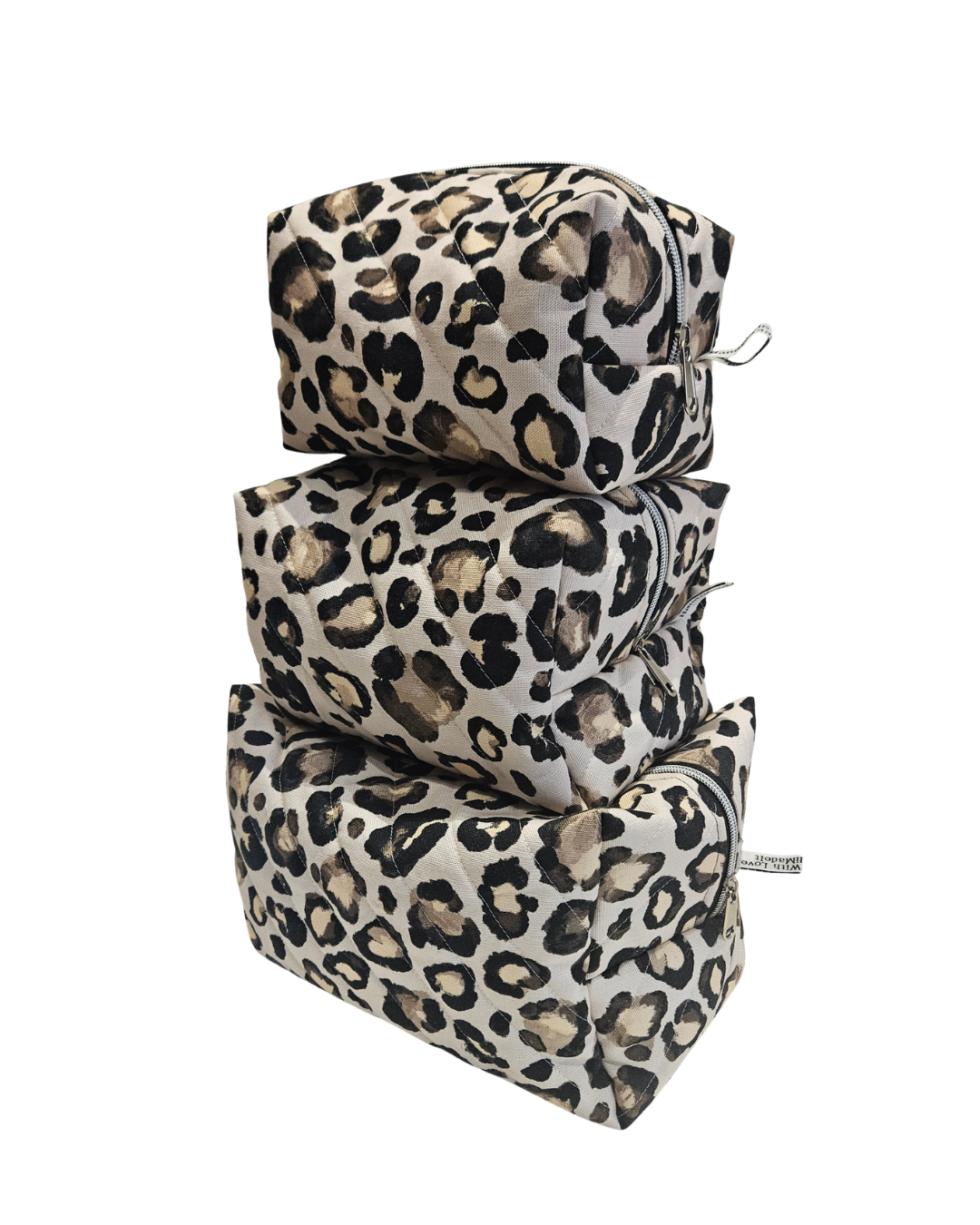 Set of three leopard print bags stacked on a white background