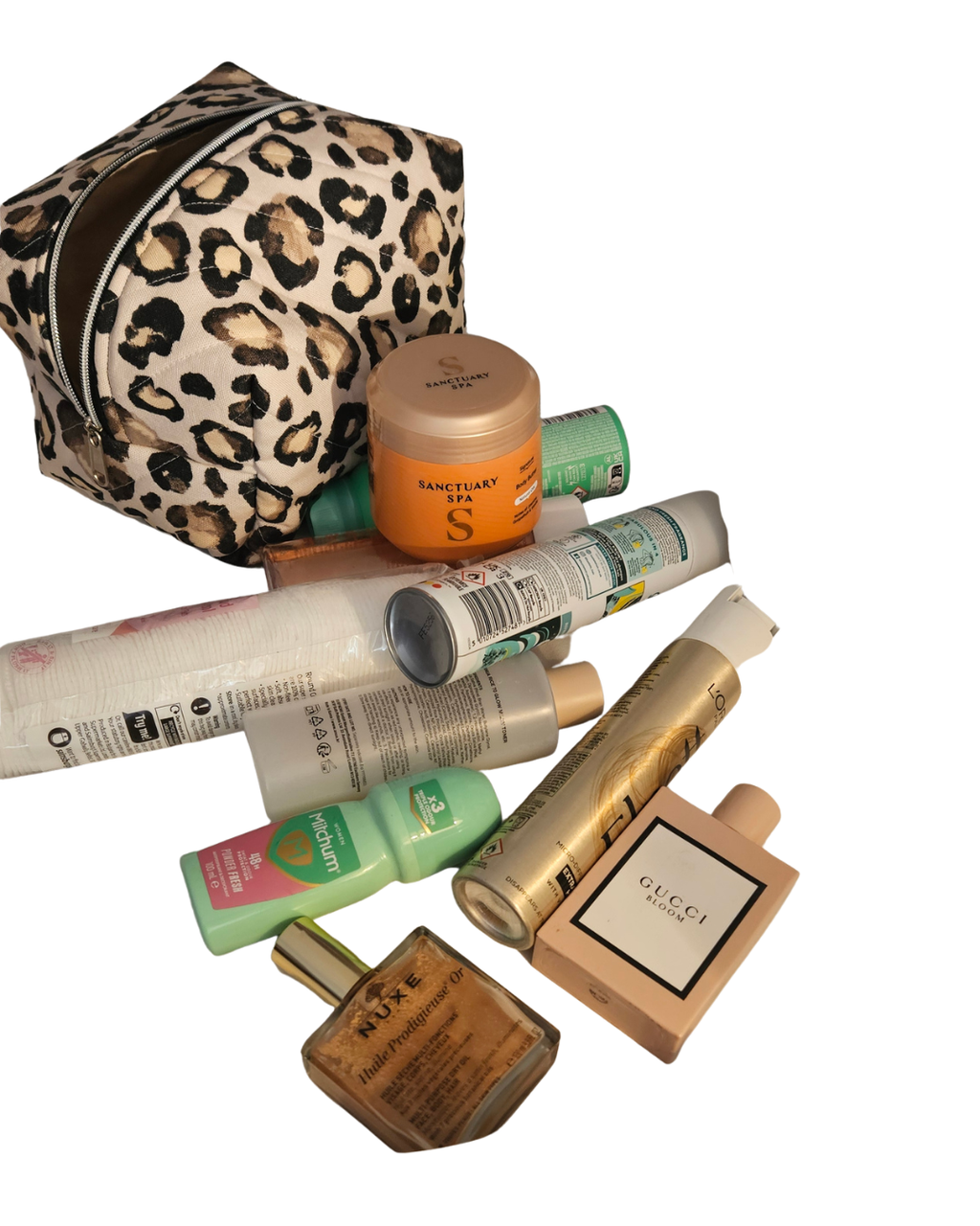Collection of beauty products including a leopard print bag on a white background