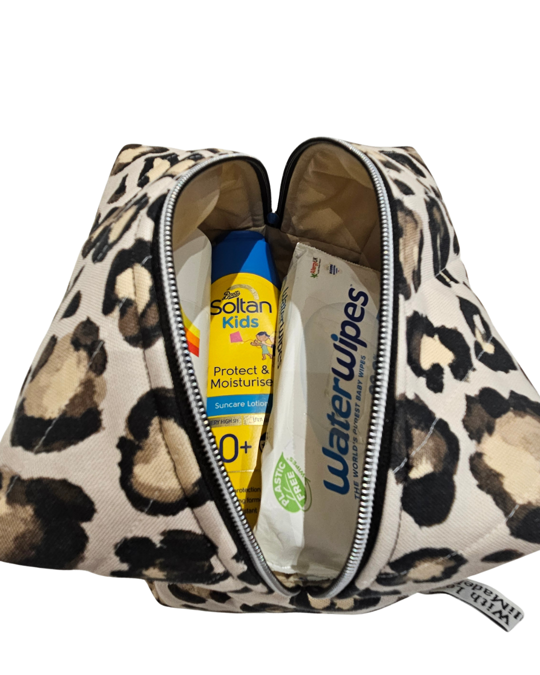 Leopard print toiletry bag with sun cream bottles.