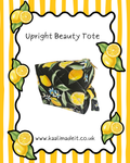 A product listing graphic for an upright beauty tote. The tote bag has a black background with a yellow lemon and green leaf pattern, along with small blue flowers.